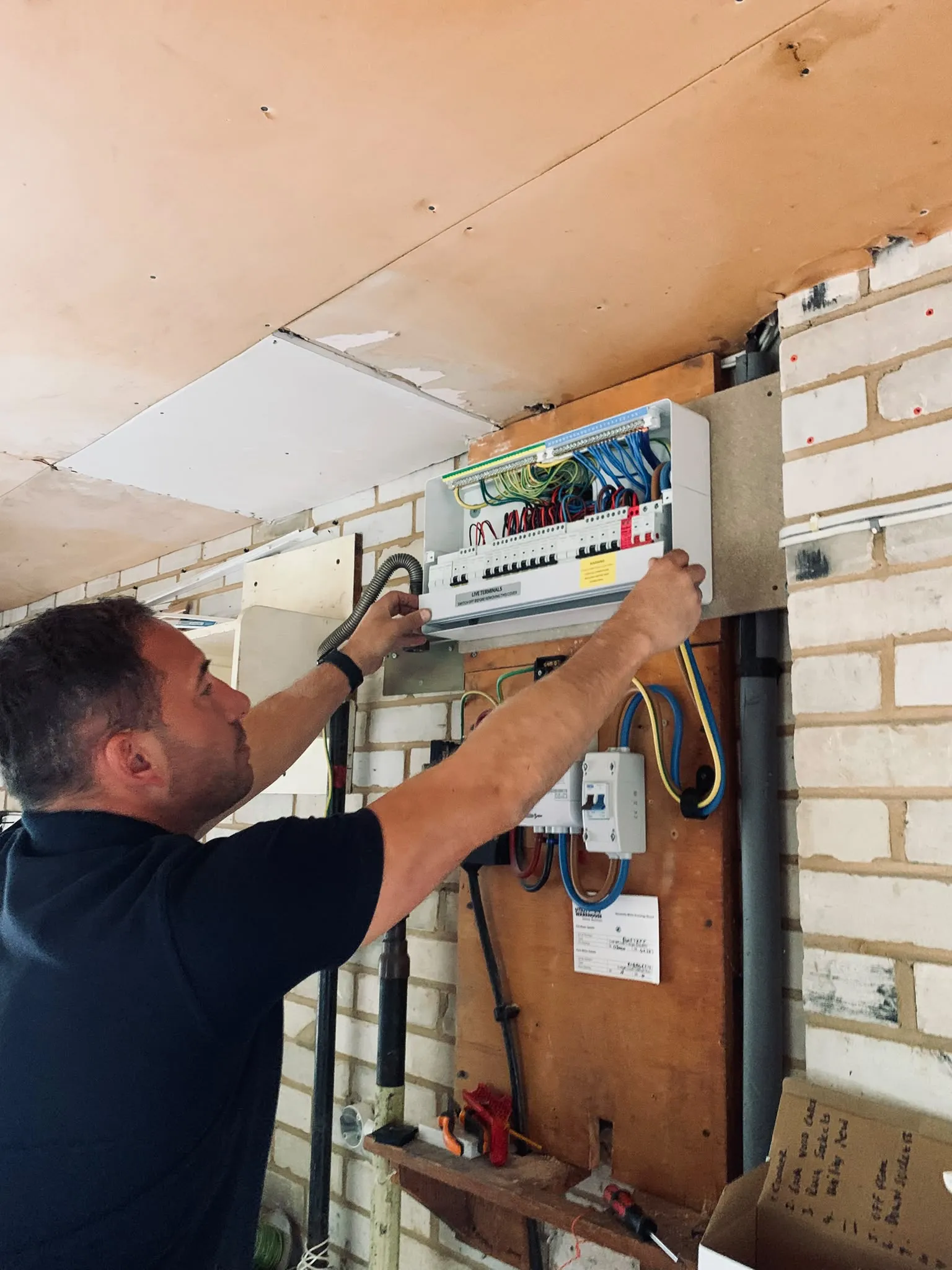 Ben using test equipment at a consumer unit